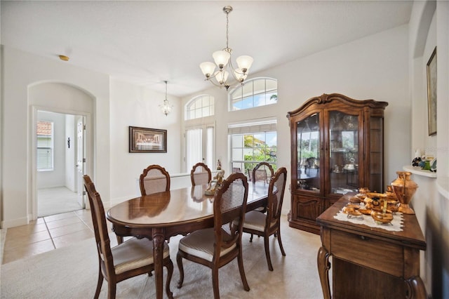 carpeted dining space featuring a notable chandelier