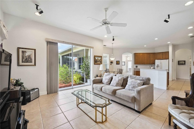 tiled living room featuring ceiling fan