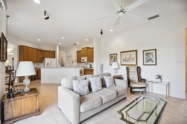 living room featuring light tile patterned floors and ceiling fan