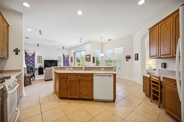 kitchen featuring ceiling fan, sink, hanging light fixtures, white appliances, and light tile patterned floors