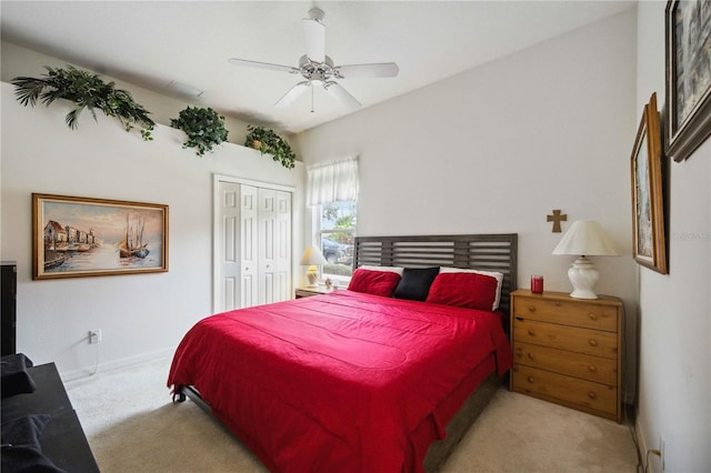 carpeted bedroom with ceiling fan and a closet