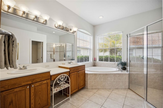 bathroom with tile patterned flooring, vanity, and plus walk in shower