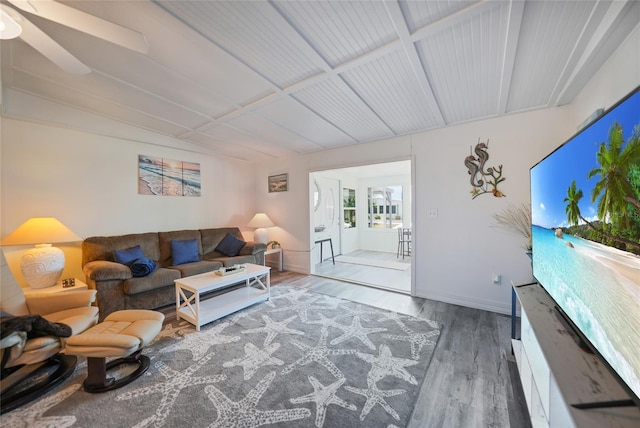 living room with baseboards and wood finished floors