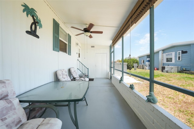 sunroom / solarium featuring ceiling fan