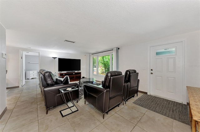 tiled living room with a textured ceiling