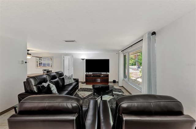 tiled living room with a textured ceiling