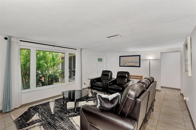 home theater with light tile patterned floors and a textured ceiling