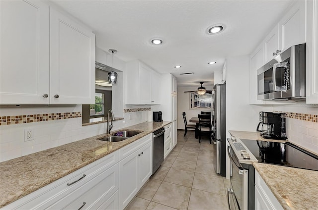 kitchen with white cabinets, appliances with stainless steel finishes, and sink