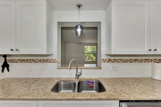 kitchen with decorative backsplash, sink, and white cabinets