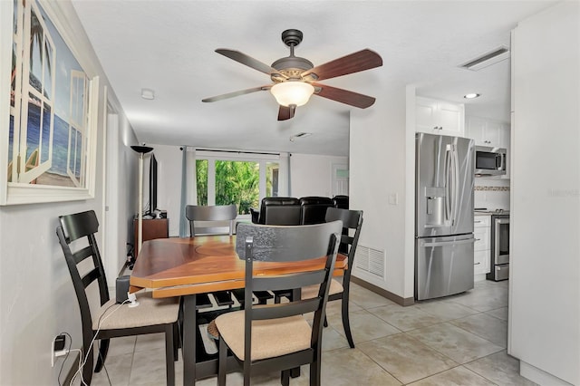 dining room featuring ceiling fan and light tile patterned flooring