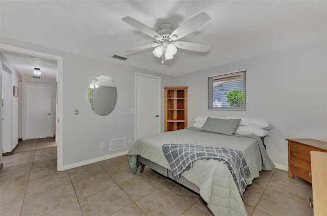 bedroom with tile patterned floors and ceiling fan