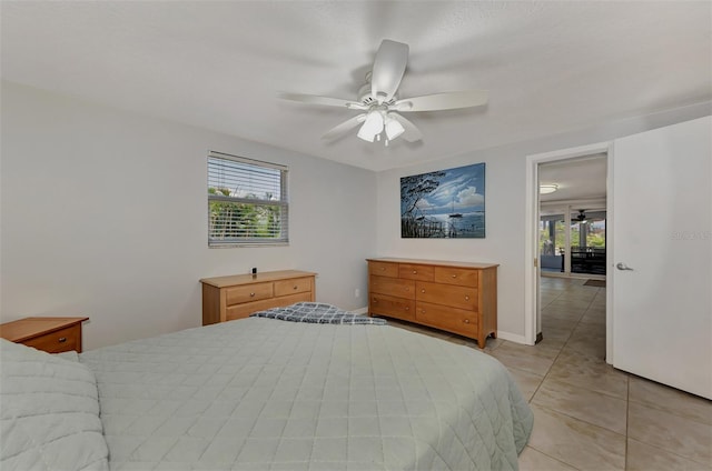 bedroom with ceiling fan and light tile patterned flooring