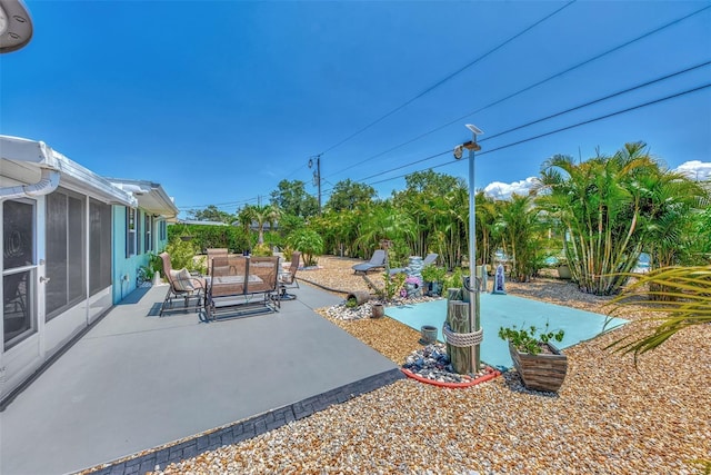 view of patio featuring outdoor lounge area and a sunroom