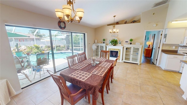 dining room with a chandelier and lofted ceiling