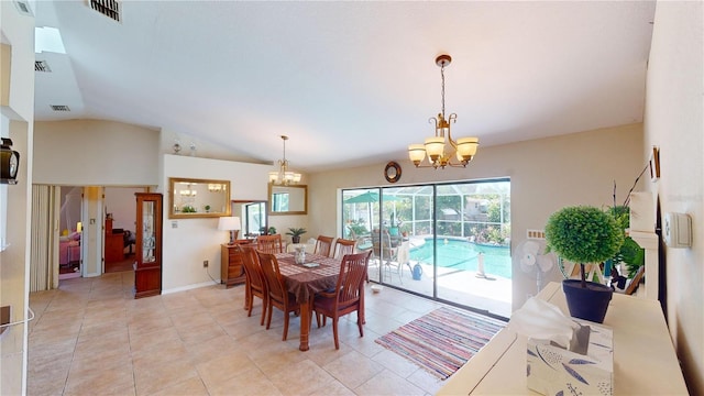 tiled dining space featuring a notable chandelier and lofted ceiling