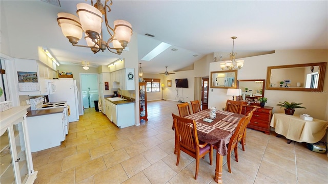 tiled dining space with lofted ceiling with skylight, sink, ceiling fan with notable chandelier, and washer / dryer