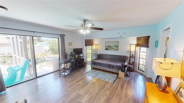 living room with ceiling fan, hardwood / wood-style floors, and a healthy amount of sunlight