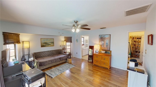 living room with ceiling fan and light wood-type flooring