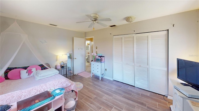 bedroom featuring ceiling fan, a closet, and light hardwood / wood-style floors