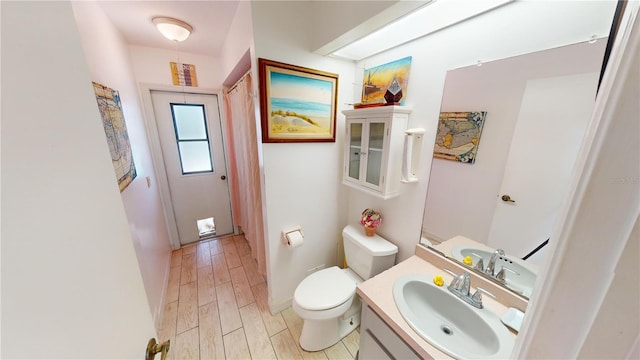 bathroom with vanity, hardwood / wood-style flooring, and toilet