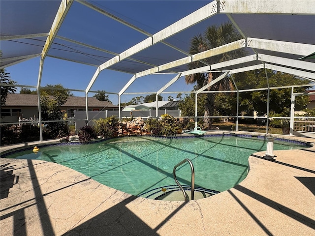 view of swimming pool with glass enclosure and a patio