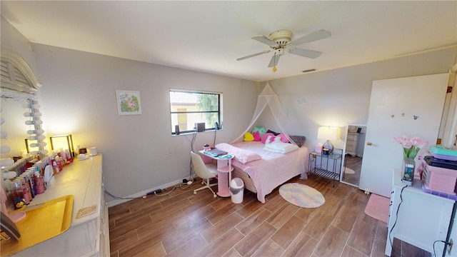 bedroom with hardwood / wood-style floors and ceiling fan