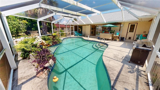 view of swimming pool featuring area for grilling, a patio area, and a lanai