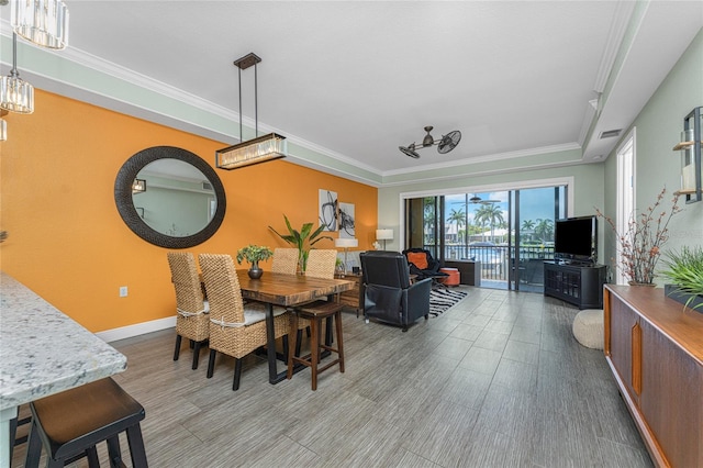 dining area featuring hardwood / wood-style floors and crown molding