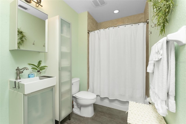 bathroom with curtained shower, vanity, and toilet