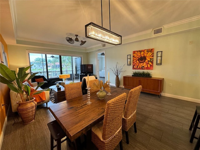 dining space with dark hardwood / wood-style floors and ornamental molding