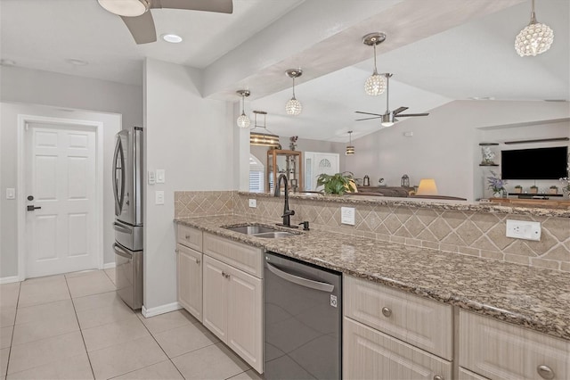 kitchen featuring decorative backsplash, sink, vaulted ceiling, and appliances with stainless steel finishes