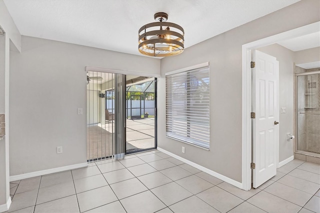 unfurnished dining area featuring light tile patterned flooring and an inviting chandelier