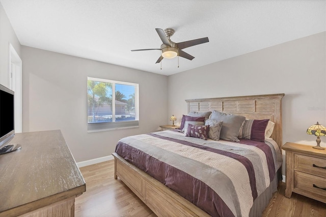 bedroom with ceiling fan and light hardwood / wood-style floors