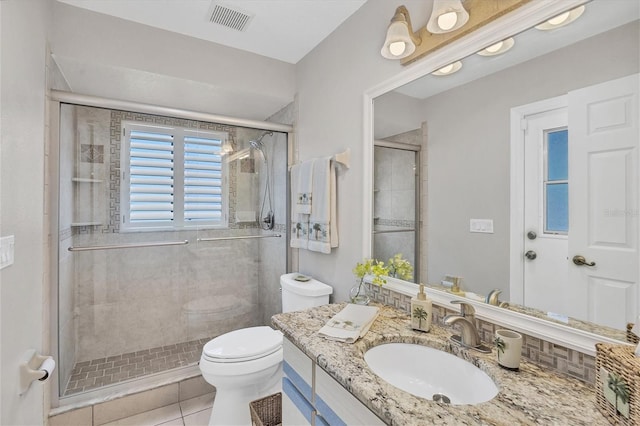 bathroom with walk in shower, tile patterned flooring, vanity, and toilet