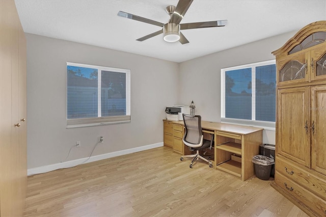 home office with ceiling fan and light hardwood / wood-style flooring