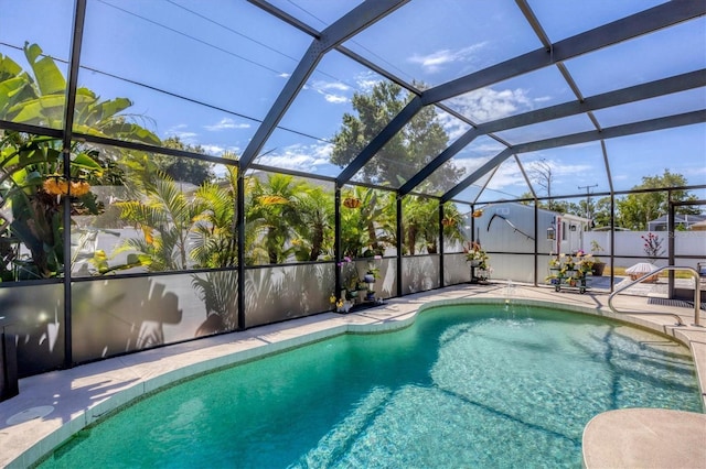 view of swimming pool with a lanai and a patio