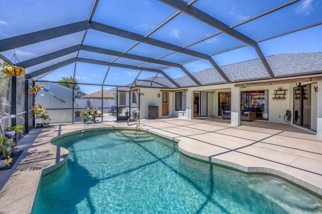 view of swimming pool featuring a lanai, a patio area, and ceiling fan