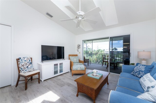 living room with hardwood / wood-style flooring, vaulted ceiling, and ceiling fan