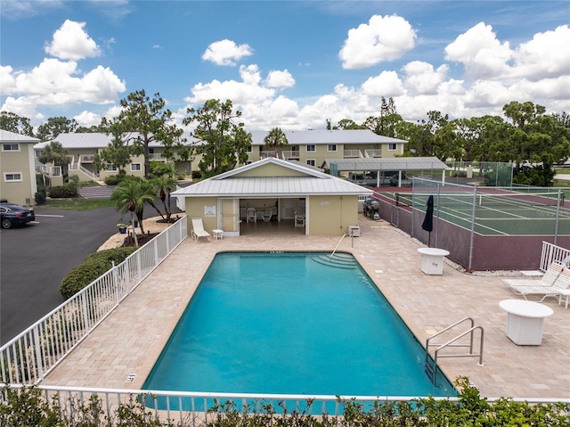 view of pool featuring a patio area and tennis court