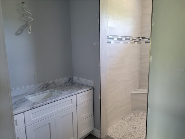 bathroom featuring vanity and a tile shower