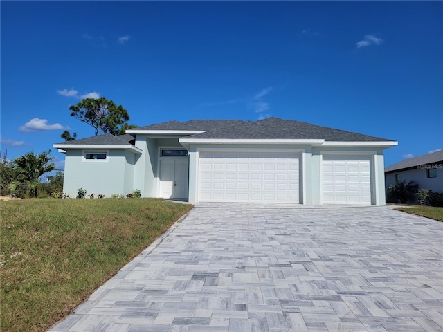 2170 Doolittle Ln, Port Charlotte, FL 33953 - prairie-style home featuring a garage, decorative driveway, stucco siding, and a front yard
