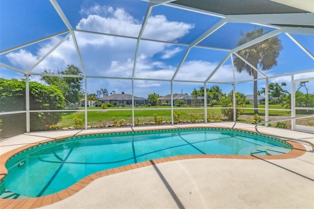 view of swimming pool featuring a patio and a lanai