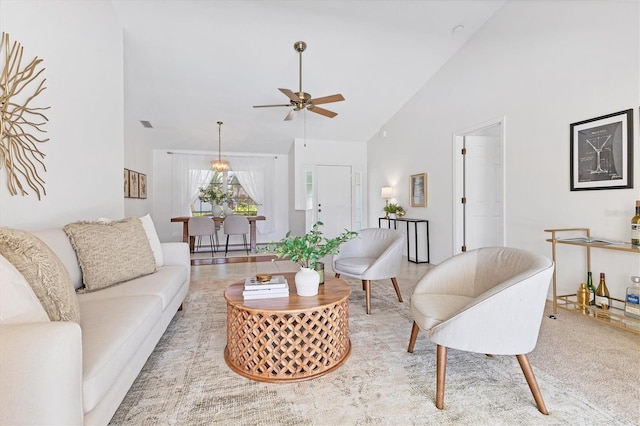 carpeted living room featuring ceiling fan and high vaulted ceiling