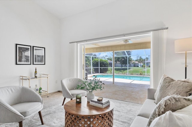 living room with light colored carpet and ceiling fan