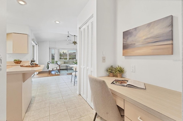 dining area with ceiling fan, light tile patterned floors, and built in desk