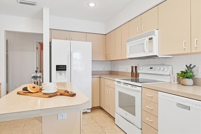 kitchen featuring decorative backsplash, light tile patterned floors, and white appliances