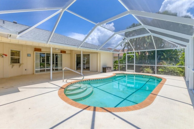 view of swimming pool featuring a lanai and a patio area