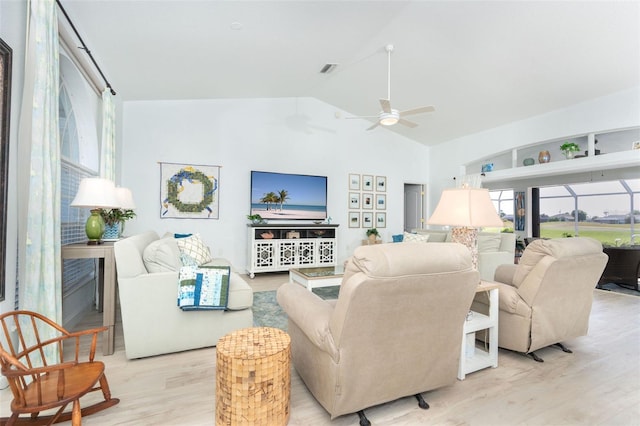 living room featuring ceiling fan, vaulted ceiling, and light hardwood / wood-style flooring