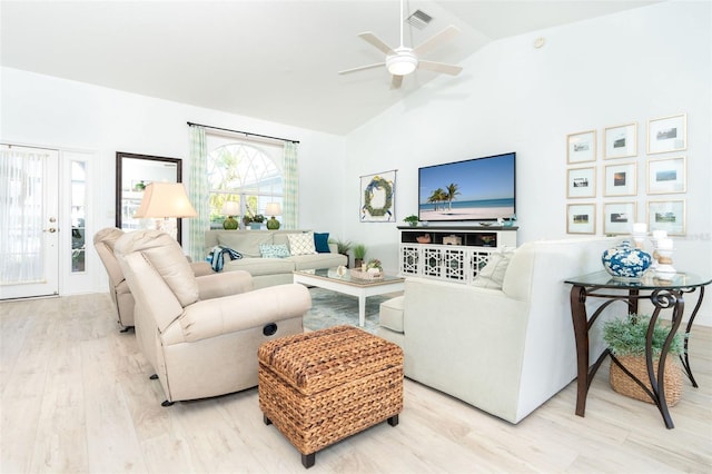 living room with hardwood / wood-style flooring, high vaulted ceiling, and ceiling fan