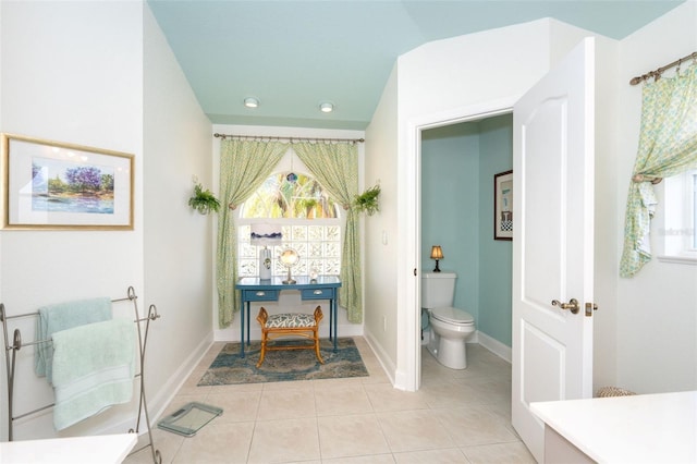 bathroom featuring tile patterned floors, vaulted ceiling, and toilet